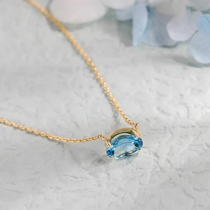 Modern Oval Blue Topaz Necklace in Solid Gold shop name